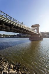 Chain Bridge in Budapest photographed from the shore on clear day, vertical