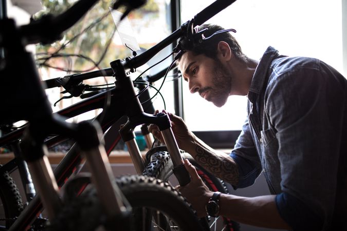 Man at a bicycle showroom making repairs