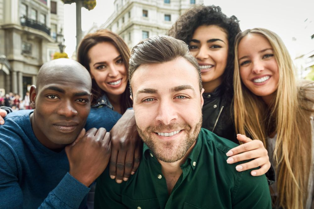 Smiling group of friends posing for selfie