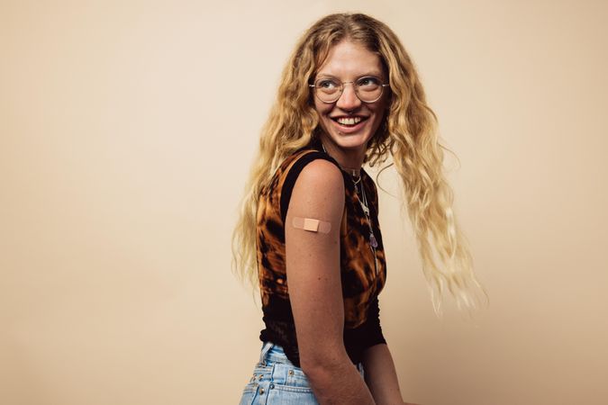 Woman looking happy after getting vaccine shot