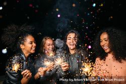 Multi-ethnic group of happy women celebrating with sparklers 4dmdNb