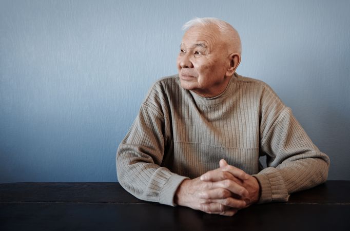 Pensive man sitting at the table