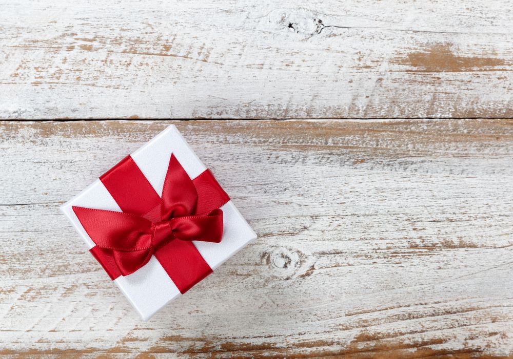 Christmas gift box on rustic wooden background
