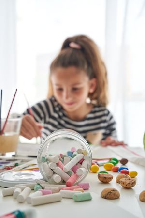 Crayons on table near girl