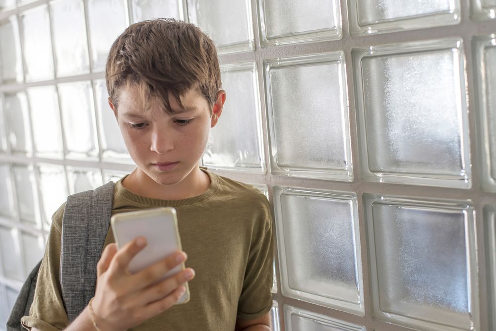 Concerned teenager looking at smartphone