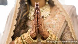 Woman in golden cultural outfit and jewelry with Mehndi tattoo 4Z3Jnb
