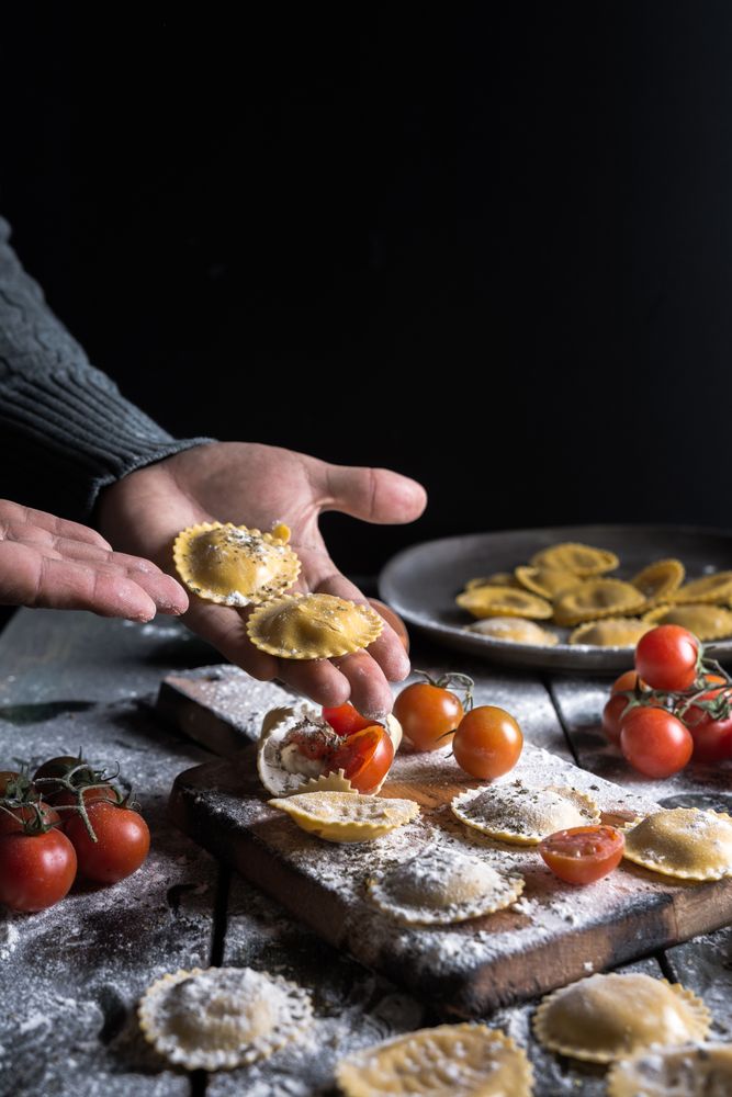 Homemade ravioli made with parmesan cheese, tomato and basil.