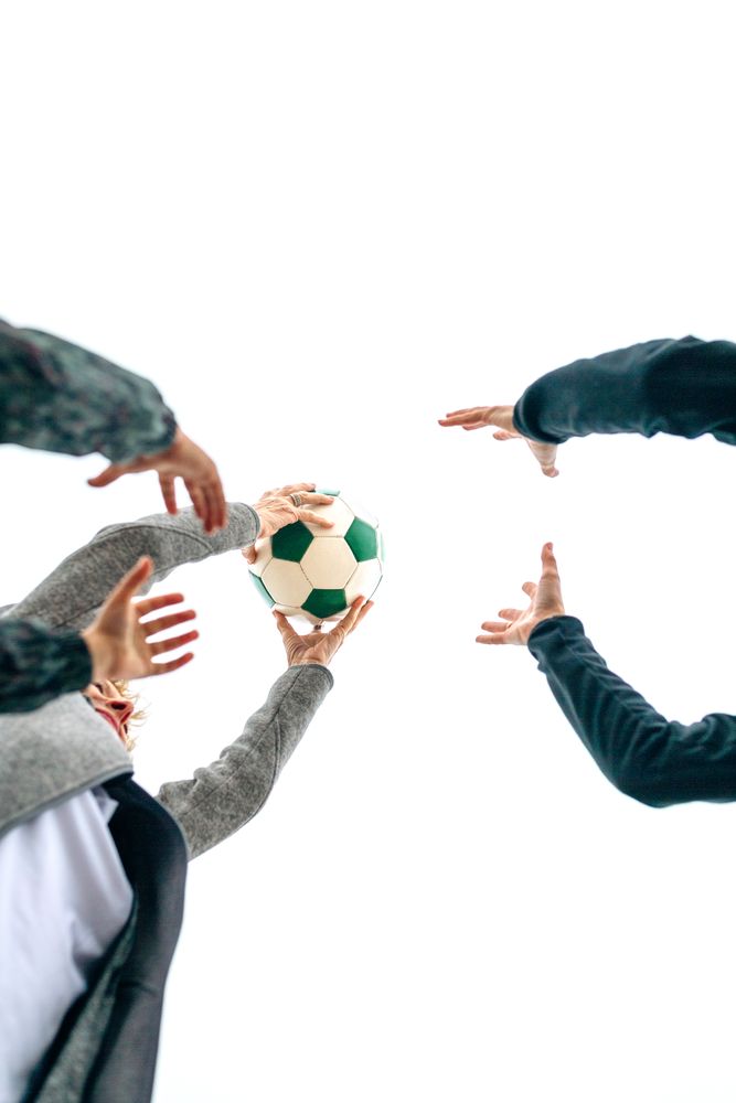Three generations playing with soccer ball