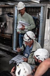 Men in bump caps at work