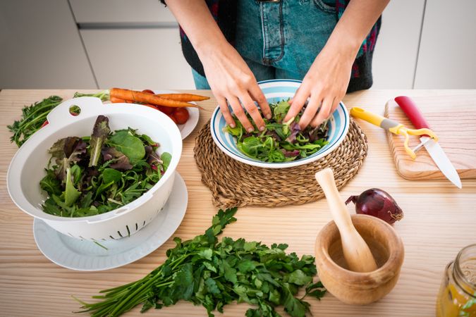 Woman preparing vegetable salad