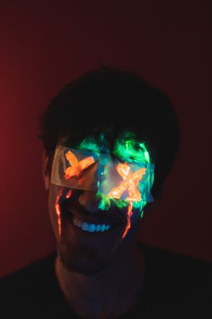 Male with covered eyes and neon face