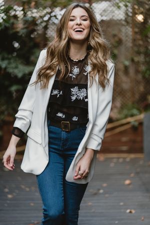 Woman standing on planter in garden