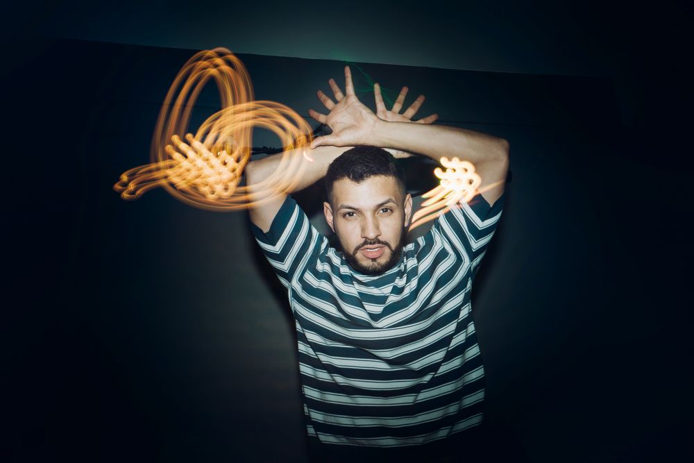 bearded man dancing in spotlight