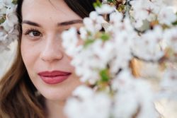 woman amidst white flowers