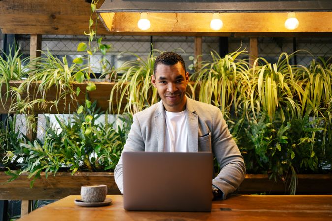 Man working on laptop at cafeteria