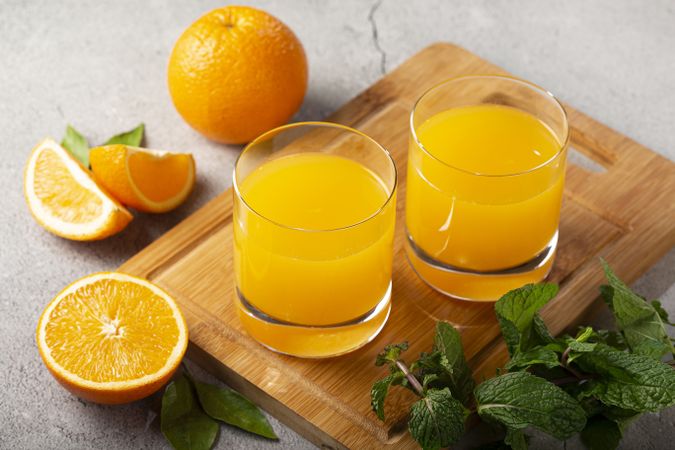 Glass with orange juice on the table.