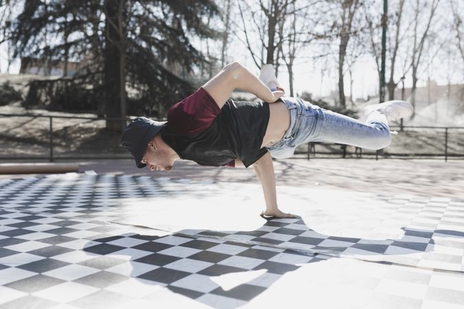 Man dancing break dance in park