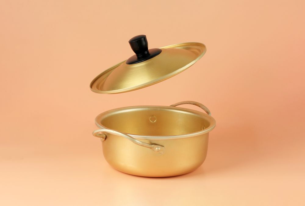 Brass pot in studio with open lid