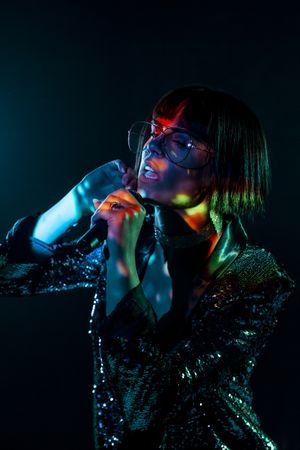 Stylish woman singing on stage