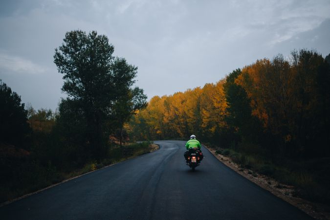 Motorcycle on mountainous road during fall