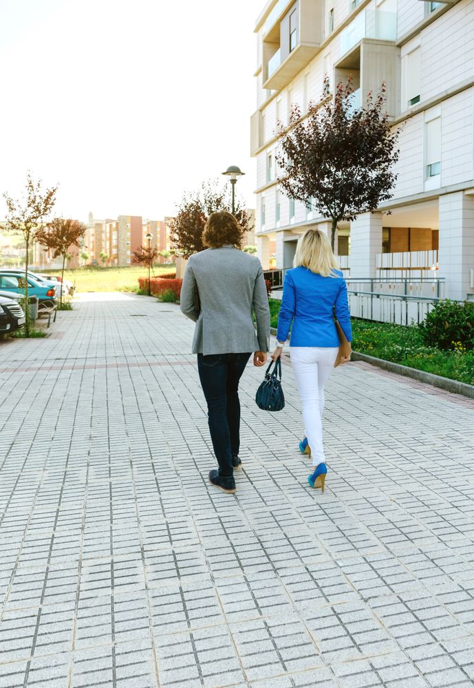 Businessman and businesswoman walking to their office