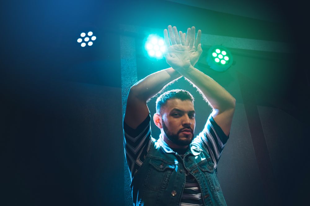 bearded man dancing in spotlight