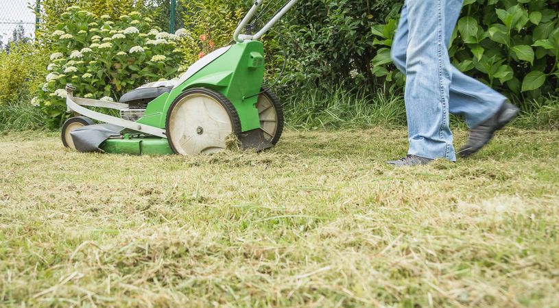 man mowing the lawn with a lawnmower