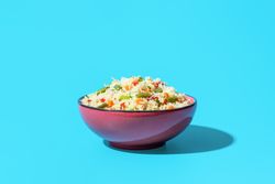 Fried rice with vegetables, an asian dish, on a blue background