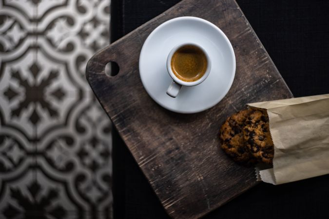 Top view of espresso and bag of cookies