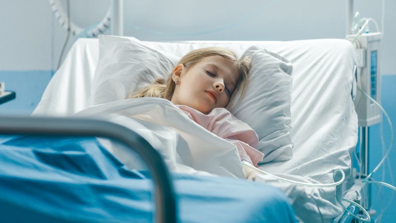 Cute Little Sick Girl Sleeps on a Bed in the Children's Hospital