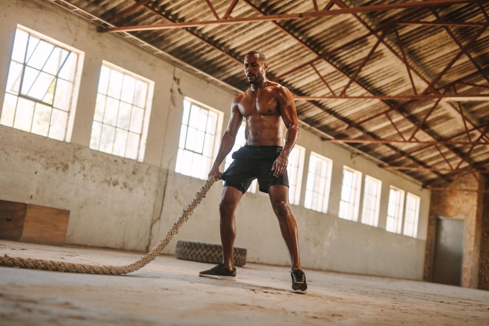 Athlete working out with battle ropes – Jacob Lund Photography