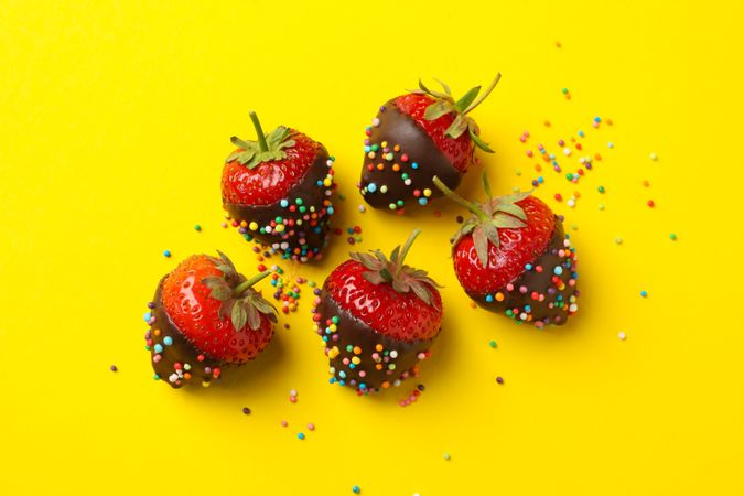 Chocolate fondue. Strawberry in chocolate on yellow background