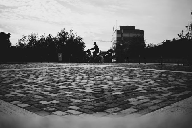 Grayscale photo of person on bicycle