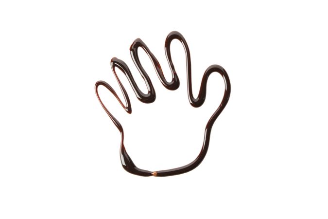 Palm made of melted chocolate isolated on plain background