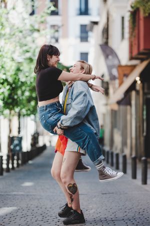 Happy lesbian couple having fun on street