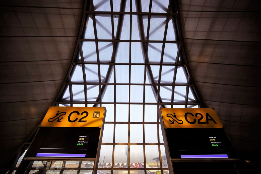 Signs at an airport with contemporary architecture