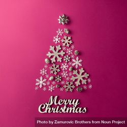 Christmas Tree made of snowflakes on pink background with “Merry Christmas” 0LPpX0
