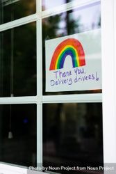 Handwritten sign with colored rainbow hanging in house window thanking delivery drivers 48BxZ0