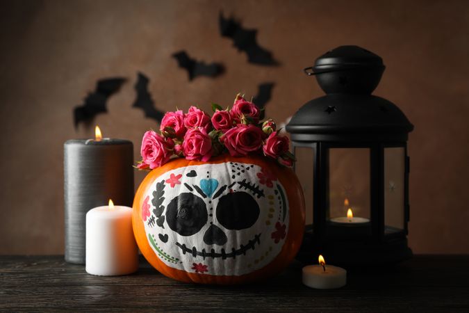 Pumpkin with catrina skull makeup and halloween accessories