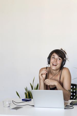 Laughing female in front of laptop in home office