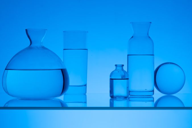 Glass Vases and Flasks on Blue