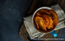 Top view of dried persimmon fruit slices in tea cup 0gXGKN