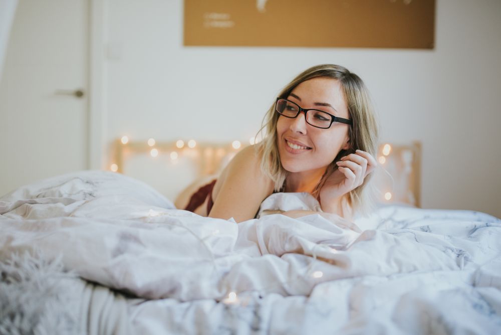 Woman lying in bed at home