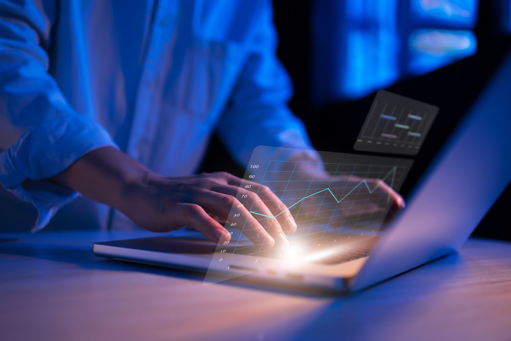 Night-time business analytics on laptop