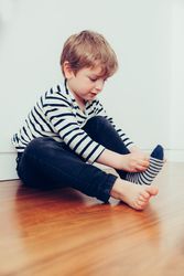 Boy wearing socks on floor