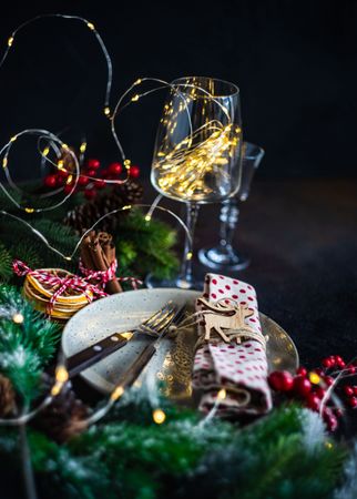 Holiday table setting with fern, dried orange and ornaments