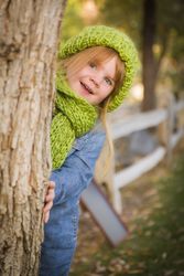 Portrait of Cute Young Girl Wearing Green Scarf and Hat