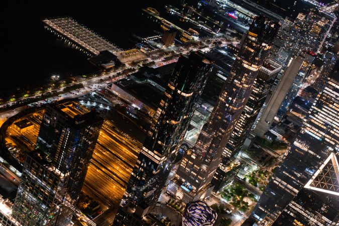 New York City Aerial Night Cityscape with Stunning Manhattan Landmarks, Skyscrapers and Residential Buildings. Helicopter Down View of the Urban Architecture