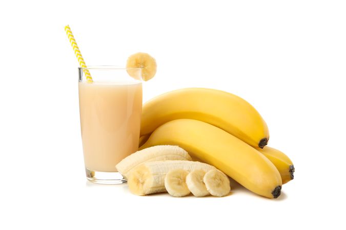 Bananas and juice isolated on light background. Fresh fruit