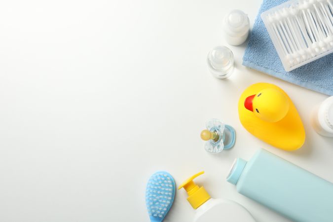 Baby hygiene accessories on light background, top view and space for text